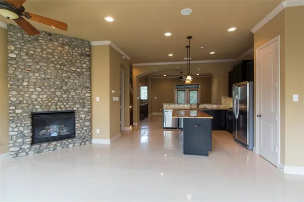 a kitchen with a refrigerator and a fireplace