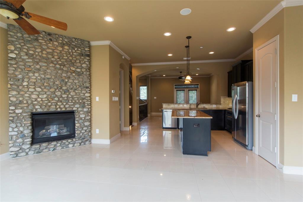 7416 Bishop Road Plano, TX 75024 - Photo 28 of 40 a kitchen with a refrigerator and a fireplace