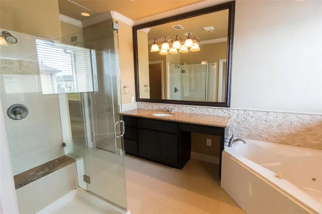 a bathroom with a bathtub a double vanity sink and mirror