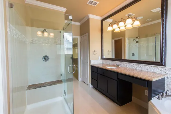 a bathroom with a double vanity sink mirror and shower