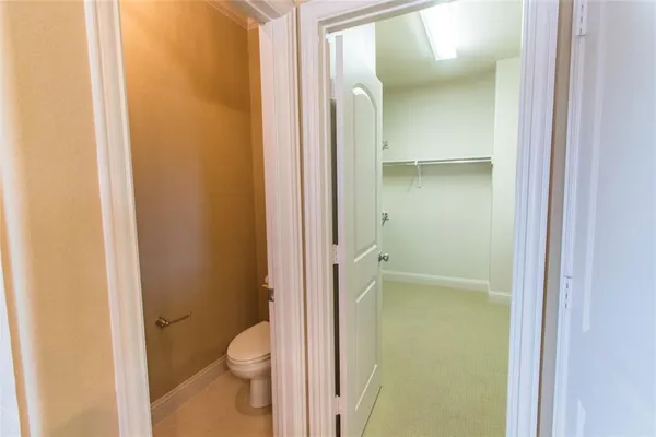 a bathroom with a granite countertop toilet and a shower
