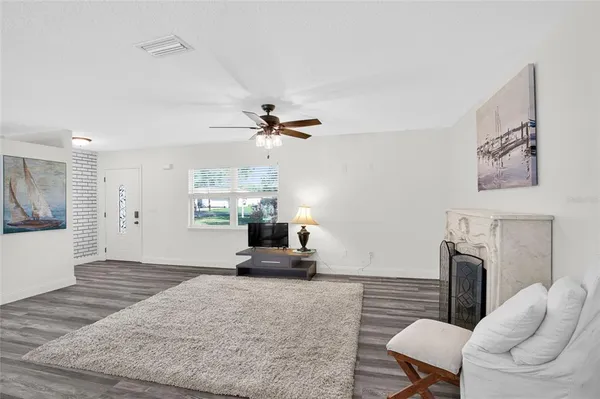a kitchen with stainless steel appliances granite countertop a kitchen island a stove a table and chairs