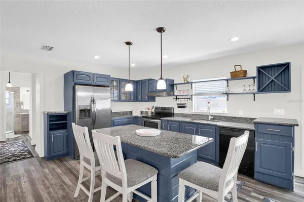 a kitchen with a stove a sink and a refrigerator