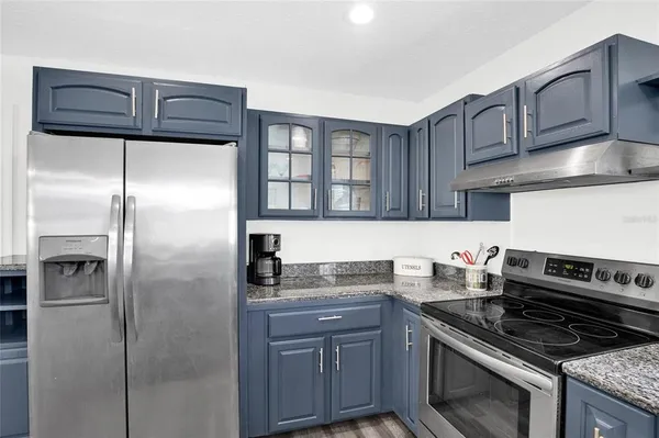 a kitchen with a table chairs and a wooden floor