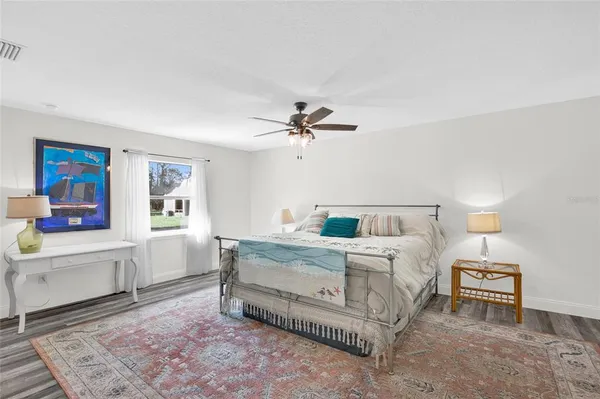 a bedroom with a large bed and a chandelier