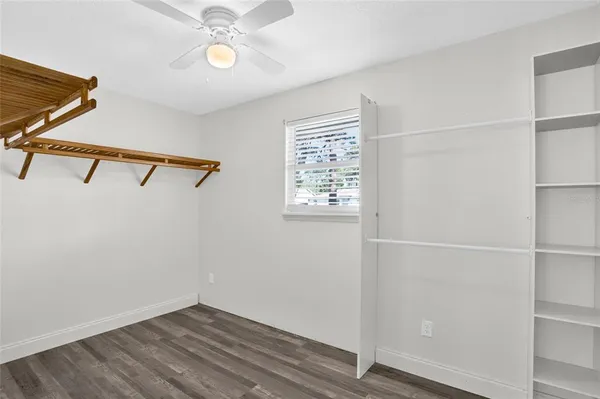 a bathroom with a granite countertop toilet sink and mirror