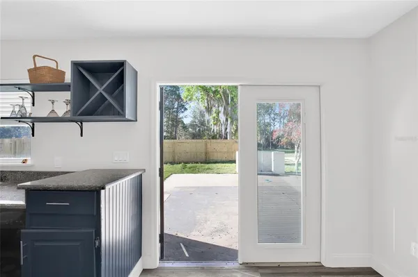 a front view of a house with a garden and trees