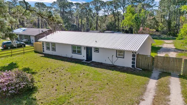 an aerial view of a house with a yard