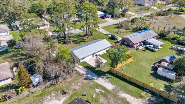 an aerial view of a house with a yard and lake view