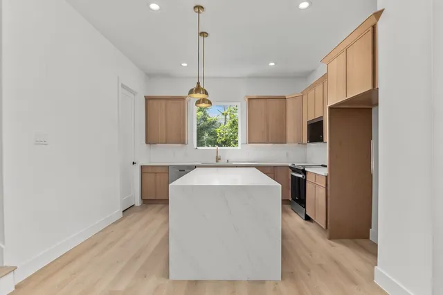 a view of a kitchen with furniture and a window