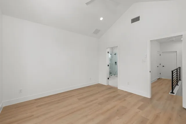 an empty room with a window and a ceiling fan