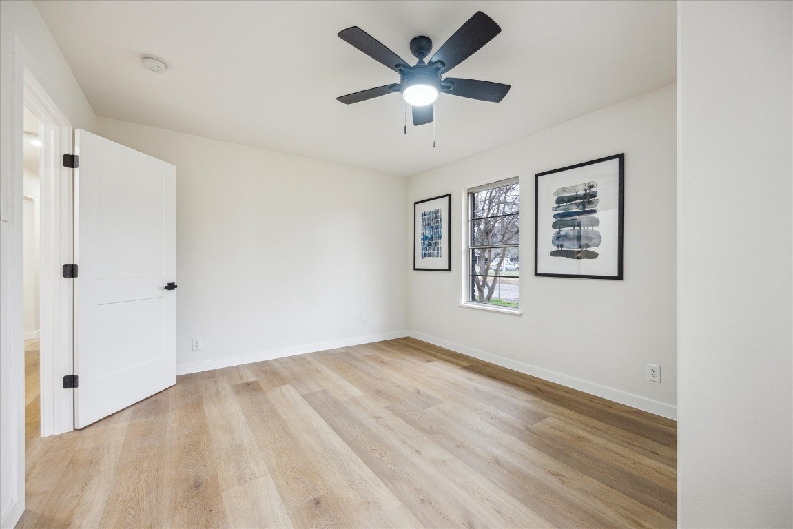 4608 Frontier Trail Austin, TX 78745 - Photo 11 of 30 a view of an empty room with window and a ceiling fan