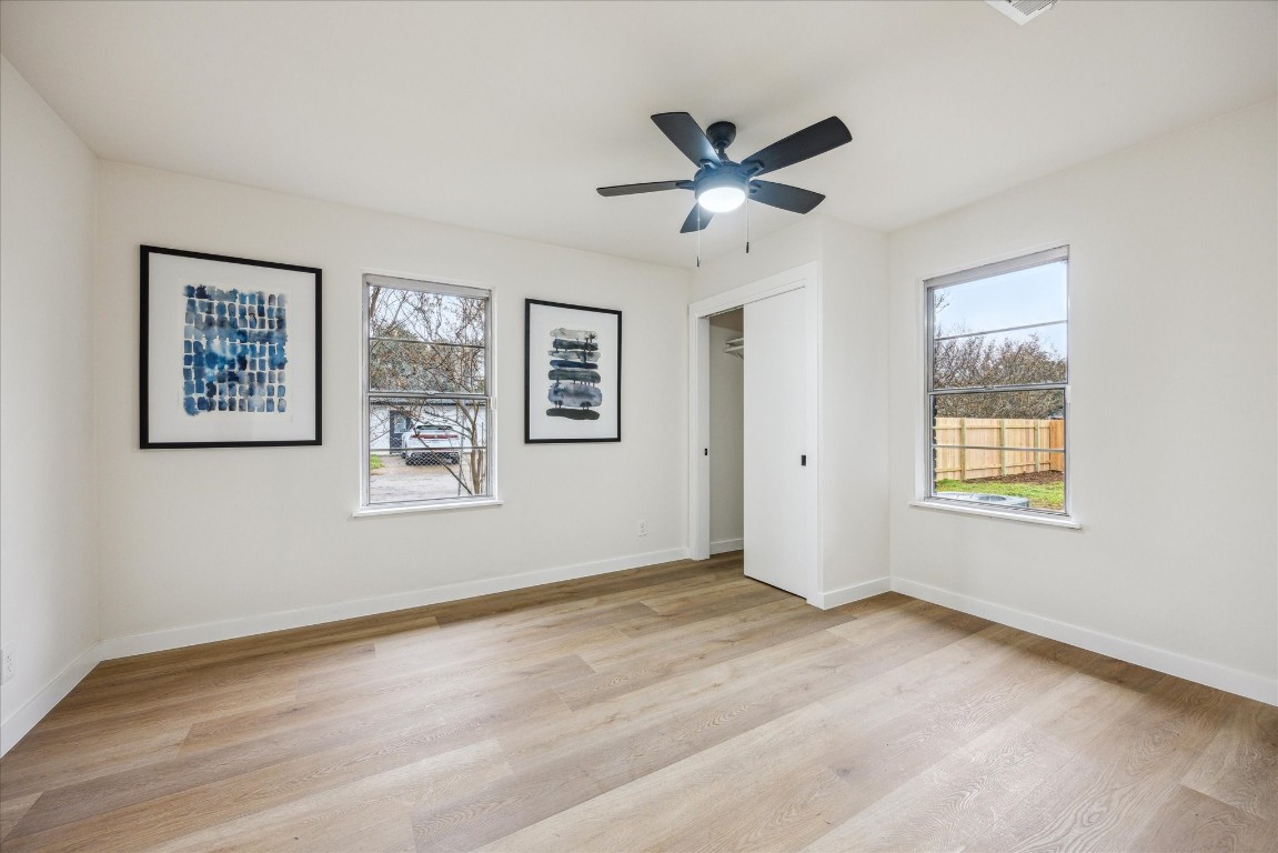 4608 Frontier Trail Austin, TX 78745 - Photo 12 of 30 a view of a big room with wooden floor and windows