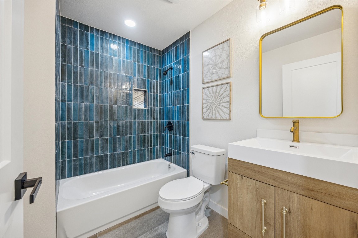 4608 Frontier Trail Austin, TX 78745 - Photo 19 of 30 a bathroom with a sink a toilet and shower