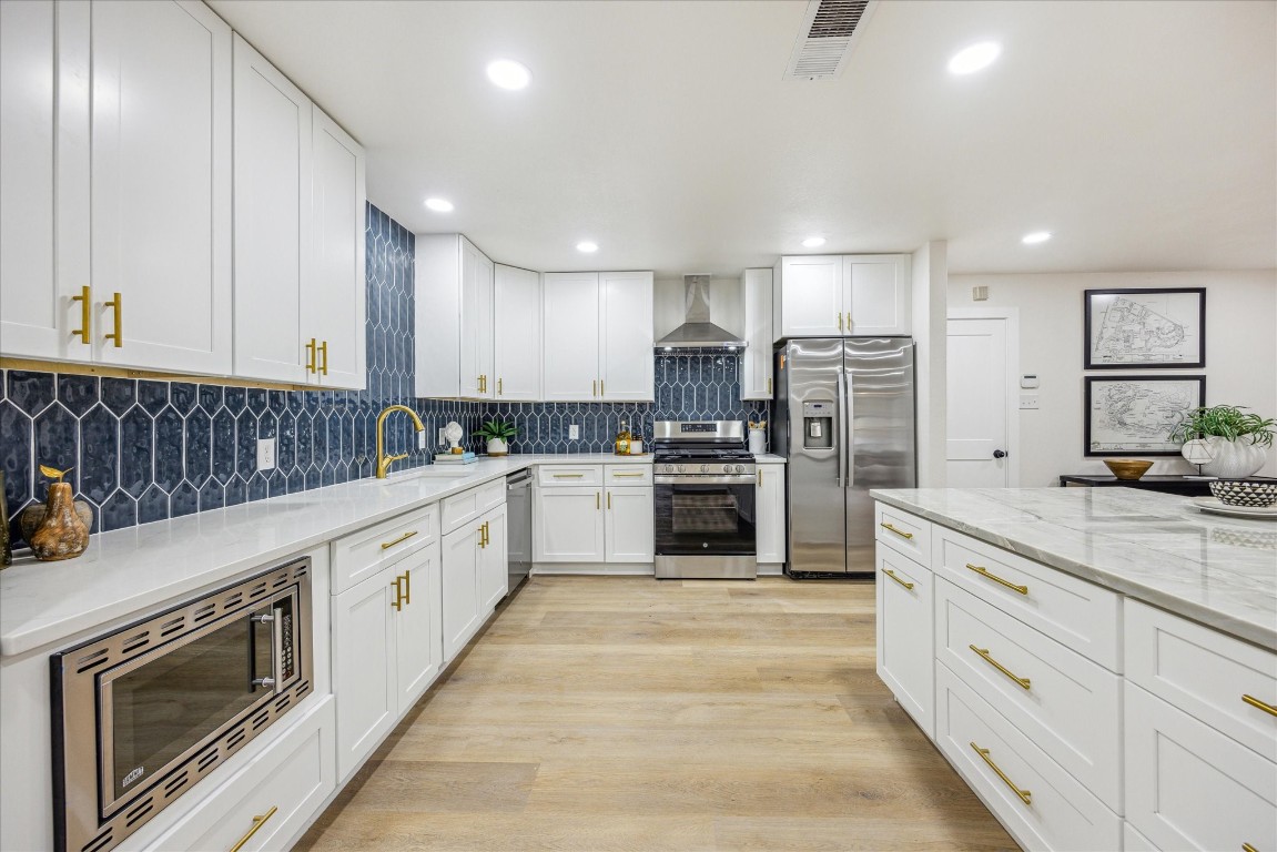 4608 Frontier Trail Austin, TX 78745 - Photo 8 of 30 a kitchen with granite countertop white cabinets and stainless steel appliances