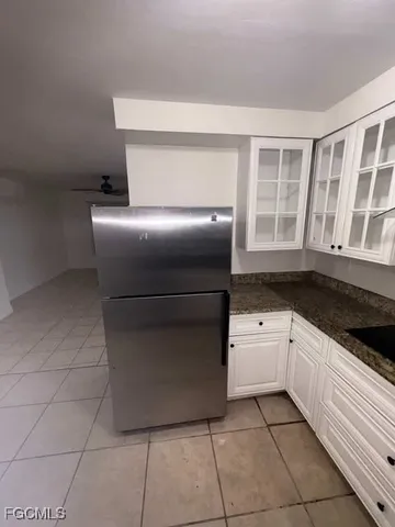 a kitchen with a cabinets and white stove top oven