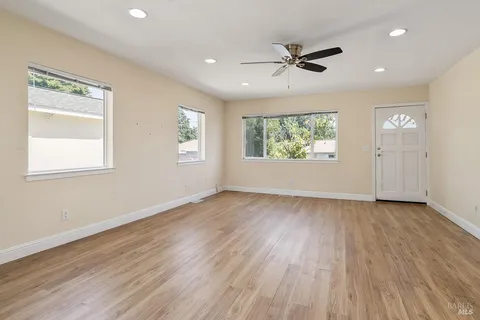 wooden floor in an empty room with a window