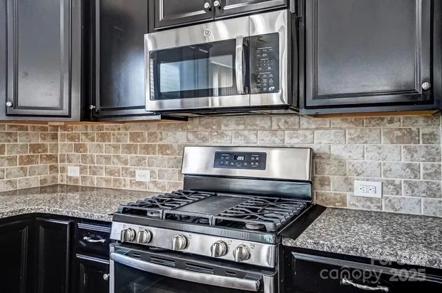 a white stove top oven sitting inside of a kitchen