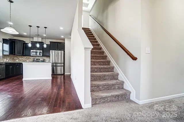 a view of kitchen with cabinets and wooden floor