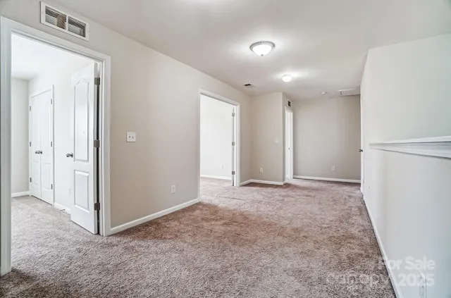 an empty room with closet and a window