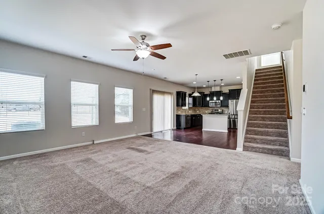 a view of a kitchen with furniture and a ceiling fan