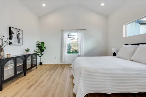 a bedroom with a bed and a window