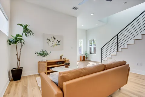 a living room with furniture and wooden floor