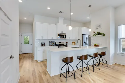 a living room with furniture and a view of kitchen