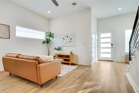 a living room with furniture and painting on the wall