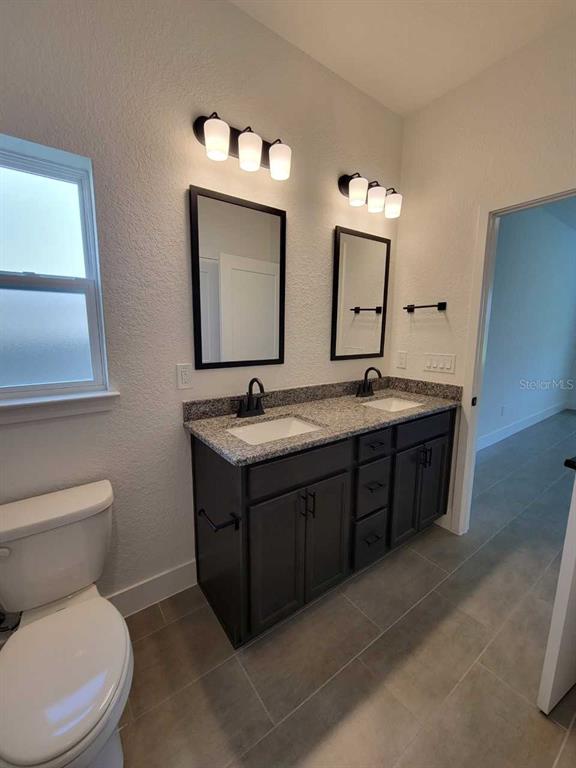 4380 Southwest 92nd Pl Road Ocala, FL 34476 - Photo 22 of 57 a bathroom with a toilet sink and mirror