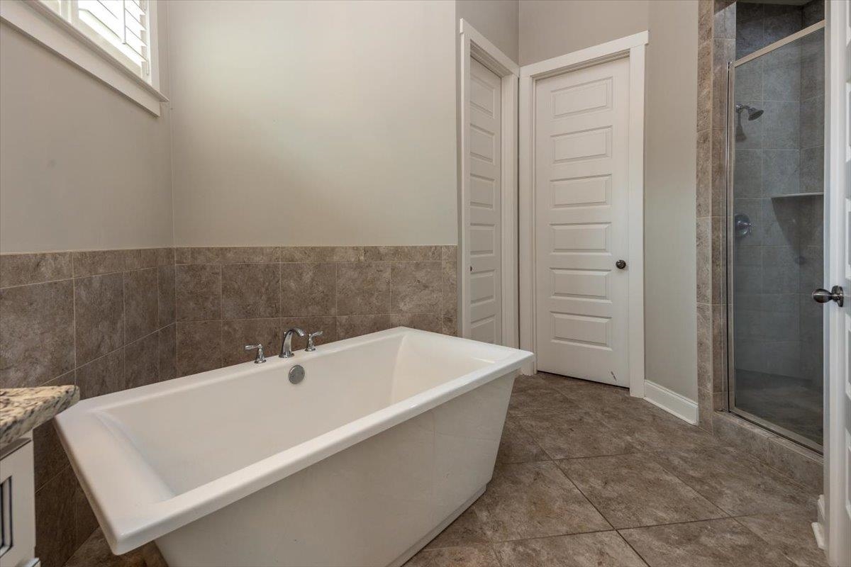 608 Cypress Run Cove Collierville, TN 38017 - Photo 20 of 40 Bathroom with a soaking tub, vanity, a stall shower, and light tile patterned floors