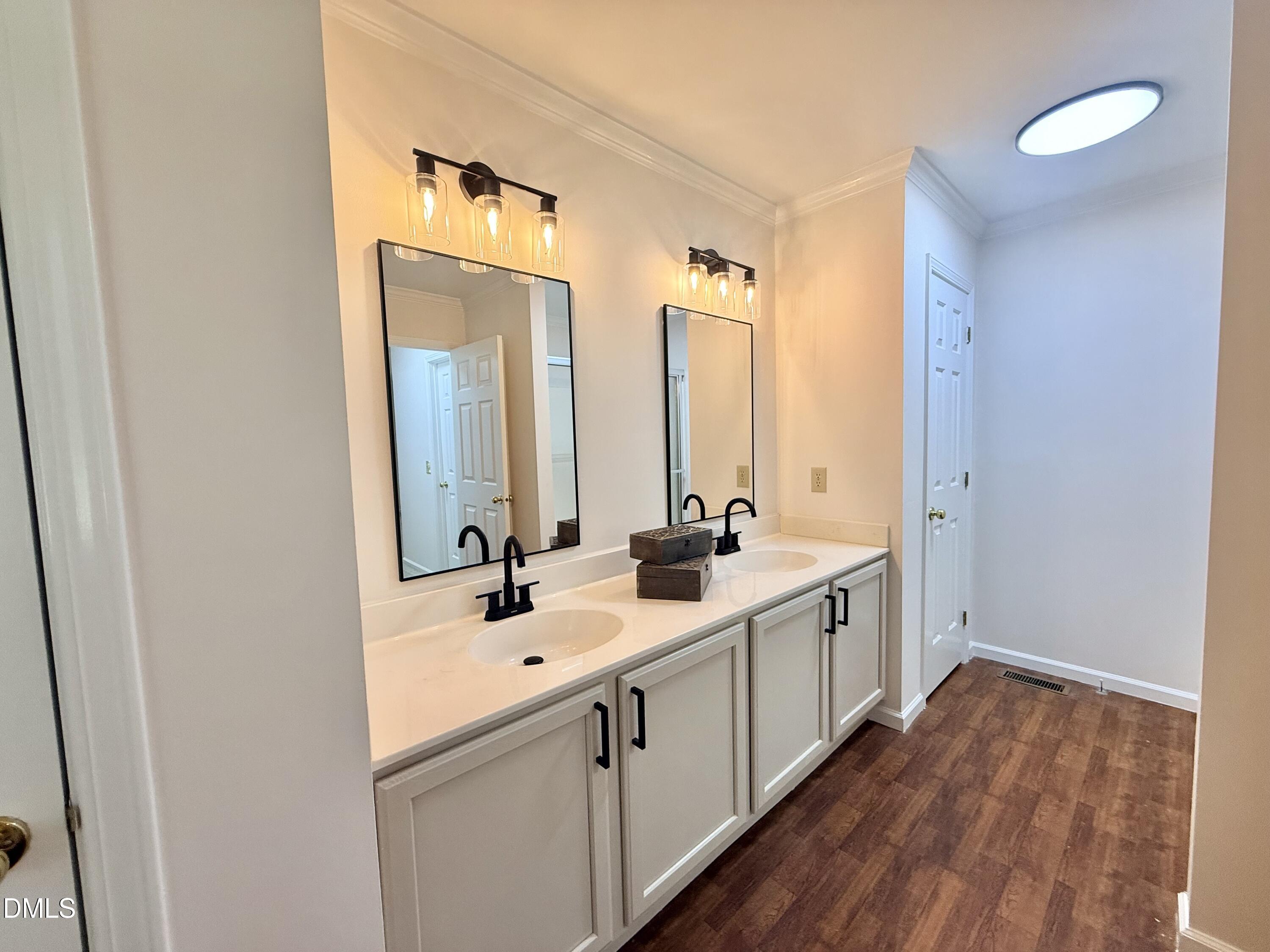 2429 Halifax Road Roxboro, NC 27573 - Photo 31 of 54 a bathroom with a double vanity sink and mirror