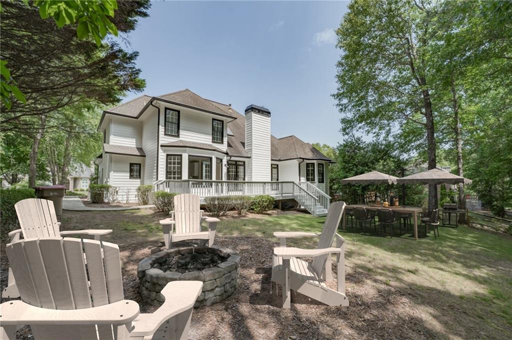 a front view of a house with garden and sitting area