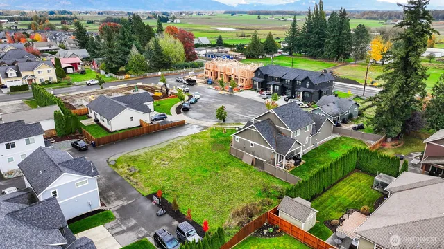 an aerial view of a swimming pool patio and yard