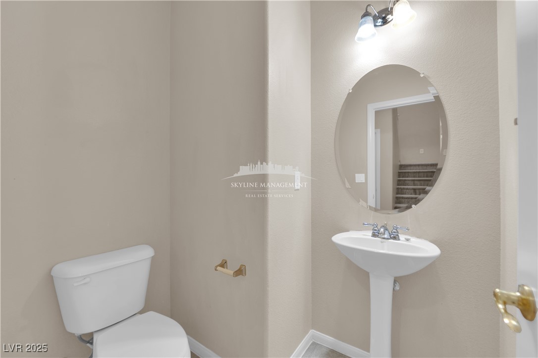 8661 Rowland Bluff Avenue Las Vegas, NV 89178 - Photo 15 of 37 Bathroom featuring toilet and baseboards
