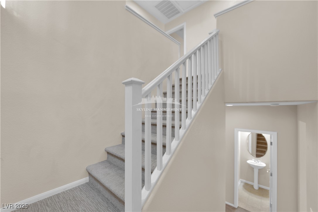 8661 Rowland Bluff Avenue Las Vegas, NV 89178 - Photo 17 of 37 Stairway featuring baseboards and carpet flooring