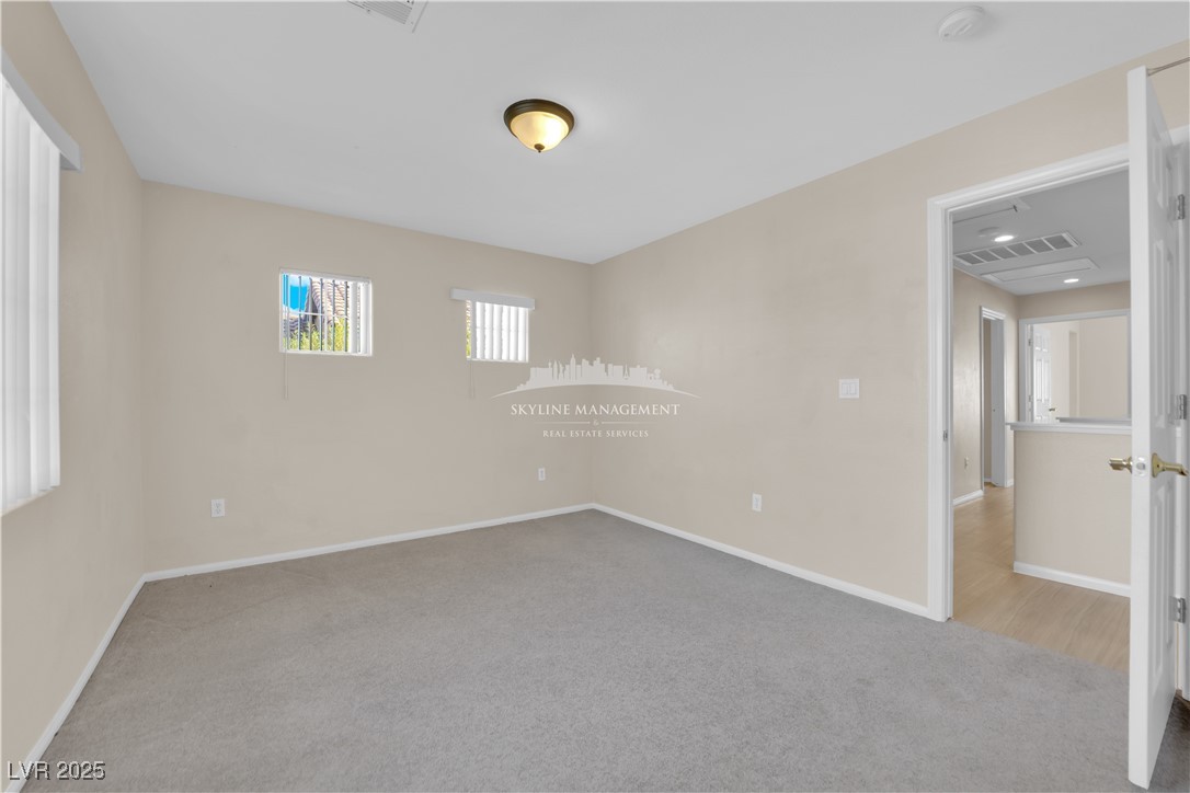 8661 Rowland Bluff Avenue Las Vegas, NV 89178 - Photo 20 of 37 Empty room with light colored carpet and baseboards
