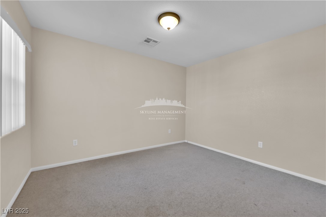 8661 Rowland Bluff Avenue Las Vegas, NV 89178 - Photo 21 of 37 Unfurnished room featuring carpet flooring and baseboards