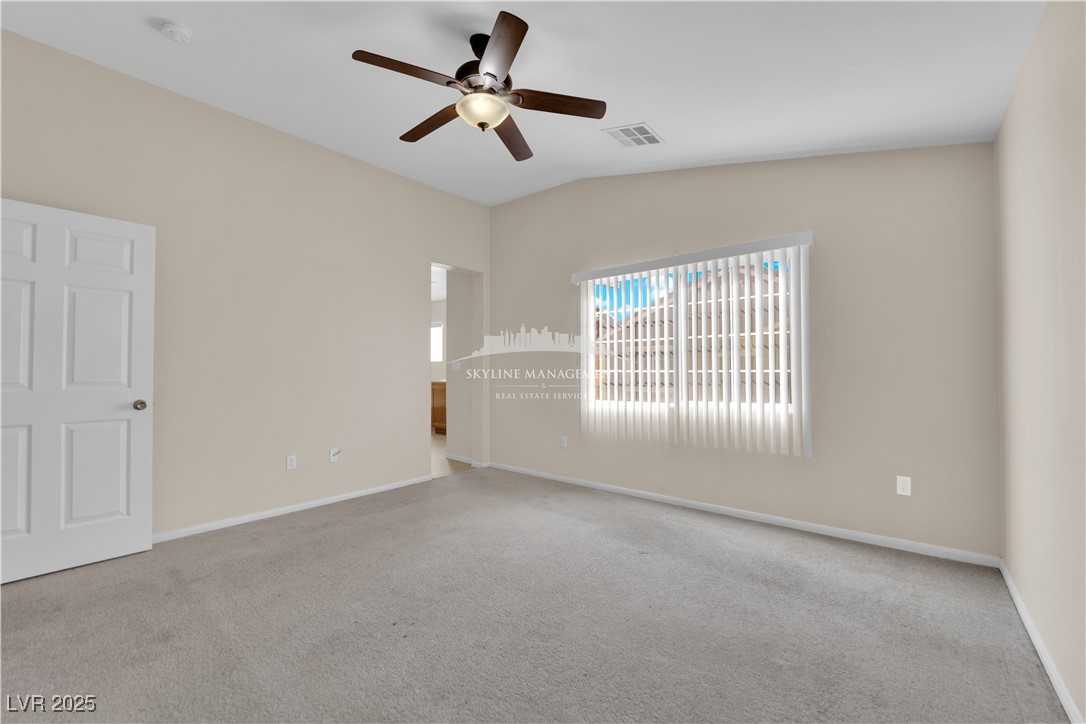 8661 Rowland Bluff Avenue Las Vegas, NV 89178 - Photo 26 of 37 Spare room featuring carpet, lofted ceiling, and ceiling fan