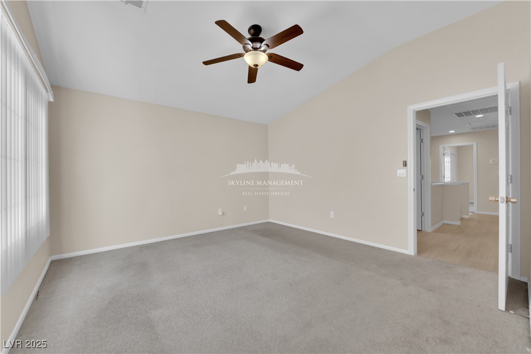 8661 Rowland Bluff Avenue Las Vegas, NV 89178 - Photo 27 of 37 Unfurnished bedroom featuring lofted ceiling, carpet floors, and ceiling fan