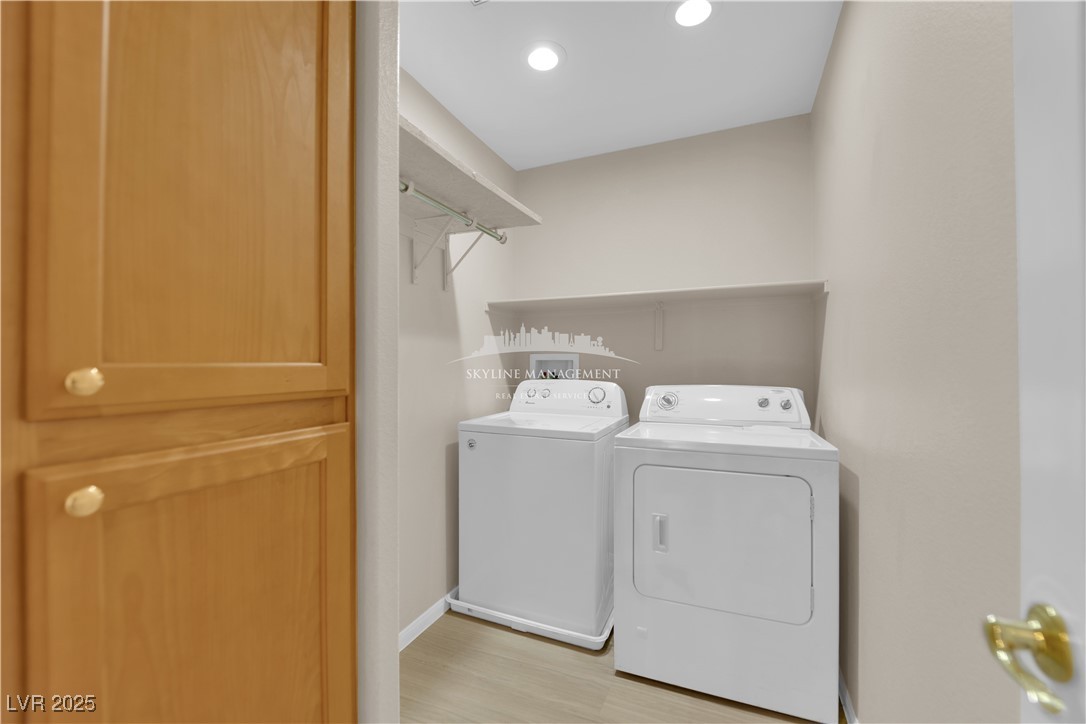 8661 Rowland Bluff Avenue Las Vegas, NV 89178 - Photo 32 of 37 Washroom with light wood-style flooring, washing machine and clothes dryer, and recessed lighting