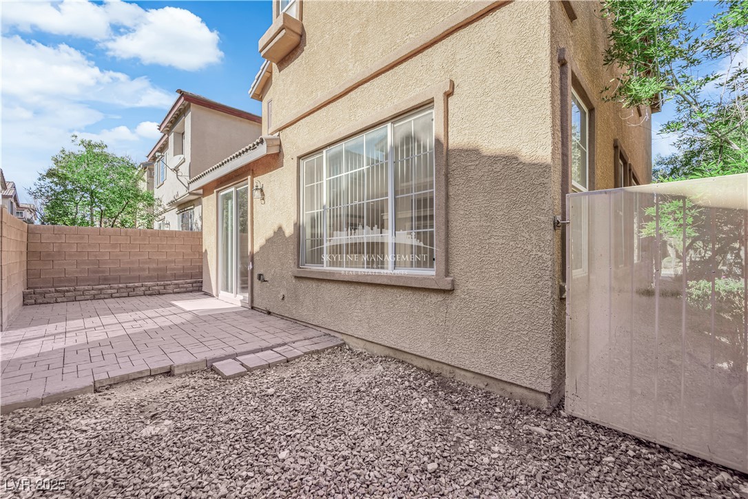 8661 Rowland Bluff Avenue Las Vegas, NV 89178 - Photo 36 of 37 View of side of home featuring a patio area, a fenced backyard, and stucco siding