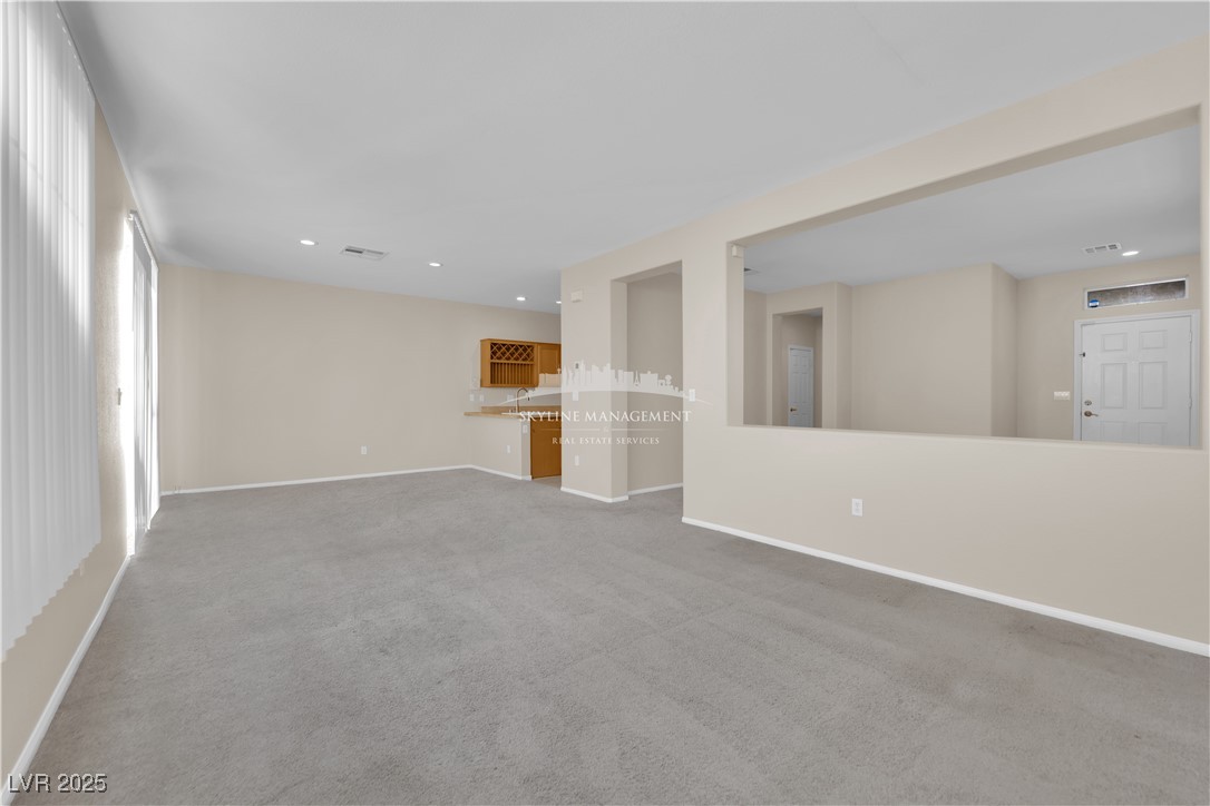 8661 Rowland Bluff Avenue Las Vegas, NV 89178 - Photo 8 of 37 Unfurnished living room with carpet floors and recessed lighting