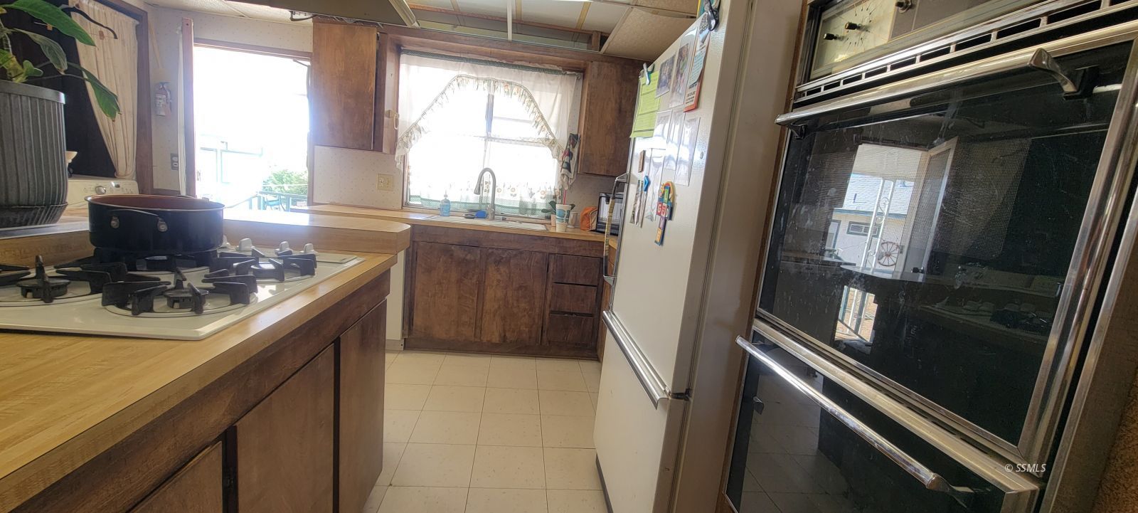 1435 West Perch Avenue Ridgecrest, CA 93555 - Photo 32 of 40 a kitchen with a sink appliances and cabinets