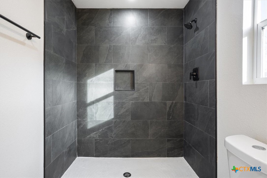 707 South 13th Street Temple, TX 76504 - Photo 17 of 24 a bathroom with a shower and toilet