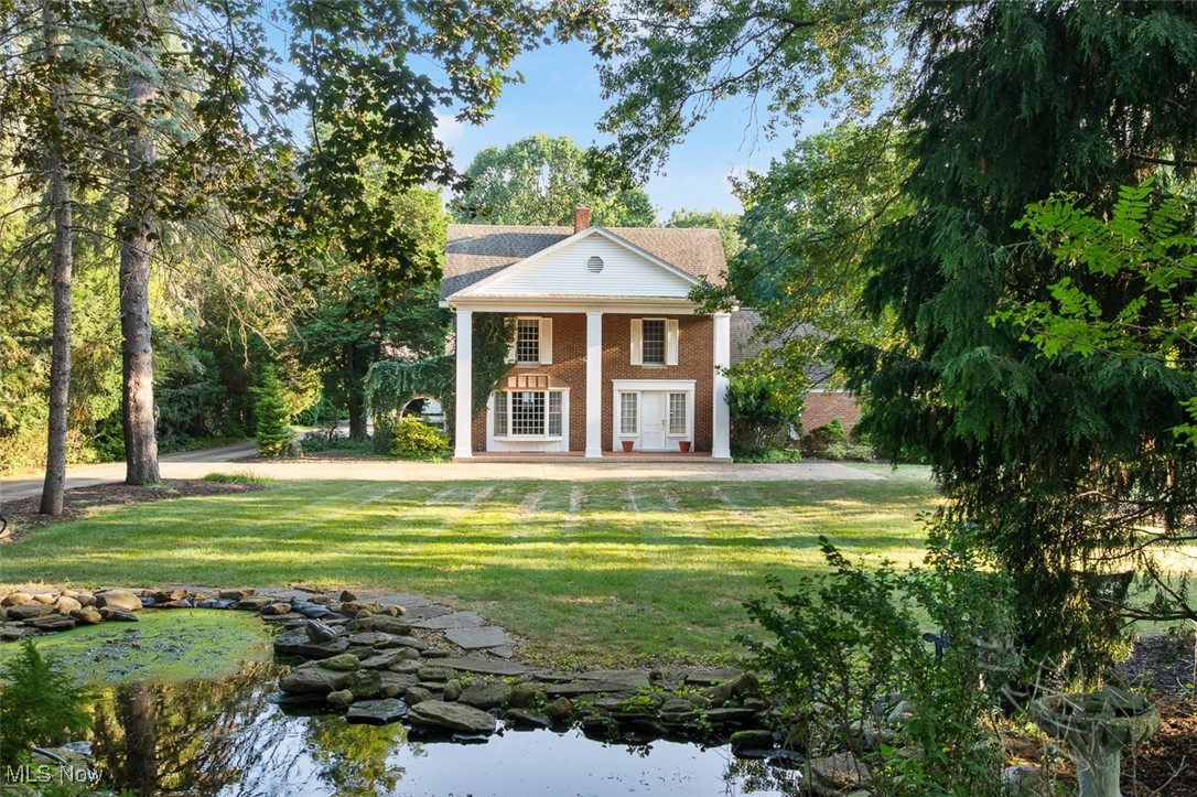 256 Everhard Road Southwest North Canton, OH 44709 - Photo 1 of 45 Greek revival house with a front yard, a porch, a chimney, and french doors