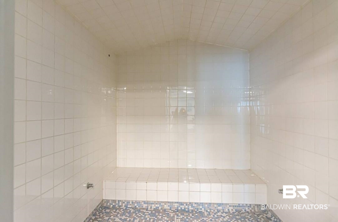 27800 Canal Road, Unit 212 Orange Beach, AL 36561 - Photo 41 of 43 Bathroom featuring lofted ceiling and a tile shower