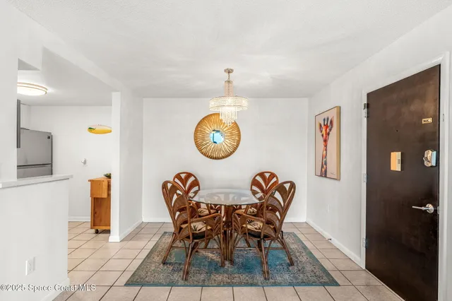a view of a dining room with furniture and a chandelier