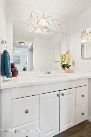a bathroom with a sink a vanity and a mirror