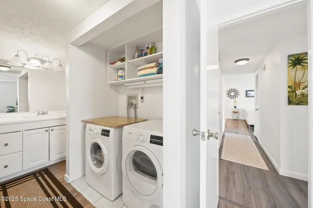 a view of a hallway with washer and dryer